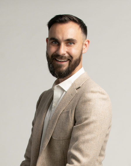 Australia's Leading Men's Sex Coach Cam Fraser smiling wearing a tweed suit